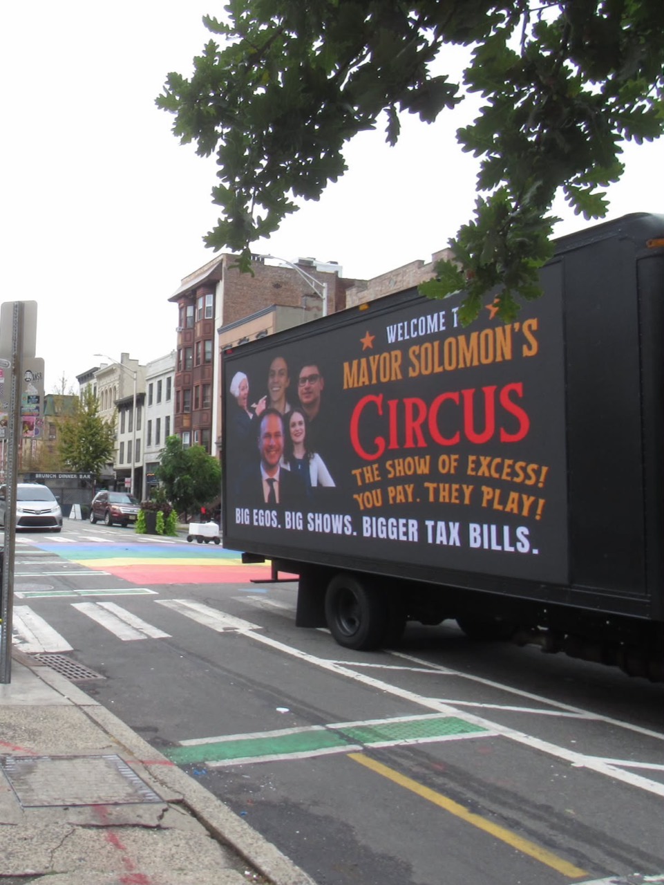 LED message truck displaying an anti-tax protest message on a Jersey City street